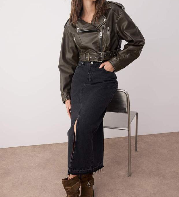 A sleek black denim maxi skirt featuring a high waist, structured fit, and front slit for ease and style. Perfect with boots, sneakers, or heels for day-to-night looks.
