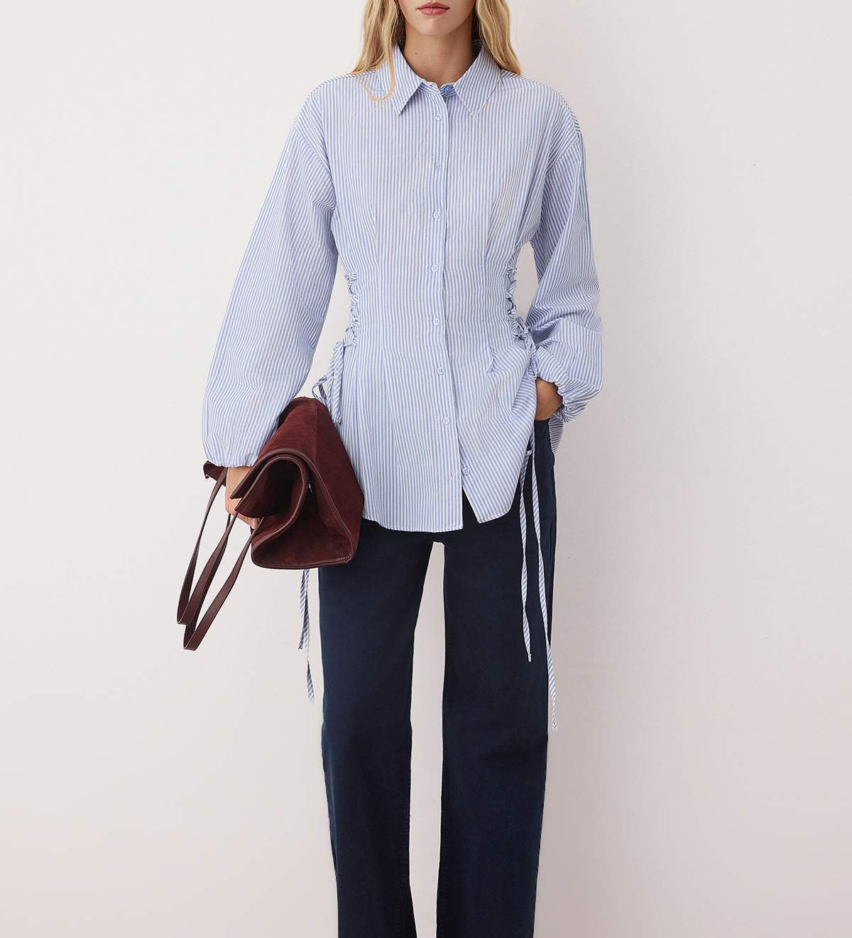  Woman wearing a blue striped button-up shirt with adjustable cinched waist ties – AtikaStyle.”
