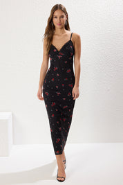 Woman wearing Atikastyle black floral slip dress with lace-trimmed neckline and midi length – elegant cami dress for women.”
