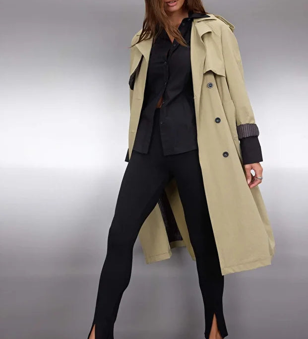 •	Woman wearing beige double-breasted trench coat with belt – AtikaStyle
	•	Front view of classic beige trench coat – AtikaStyle
	•	Long beige belted trench coat styled with black outfit – AtikaStyle
