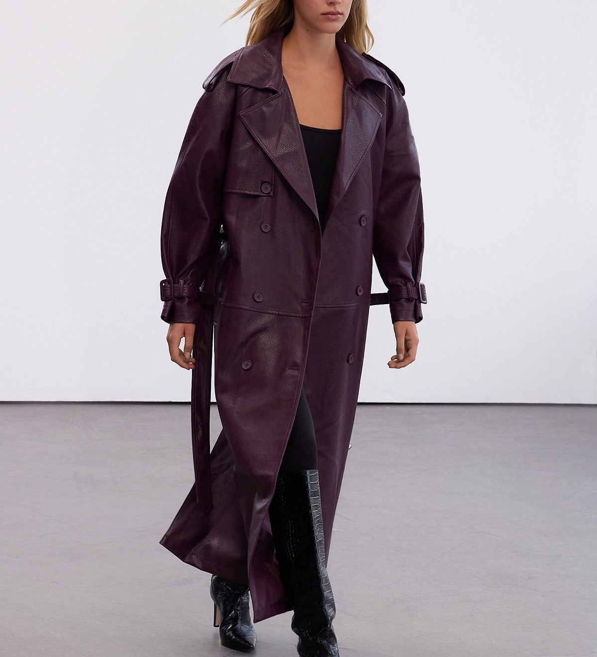 Step out in style with our Plum Faux Leather Trench Coat. This oversized longline jacket in a rich plum color is perfect for layering and making a bold statement. Shop now!
