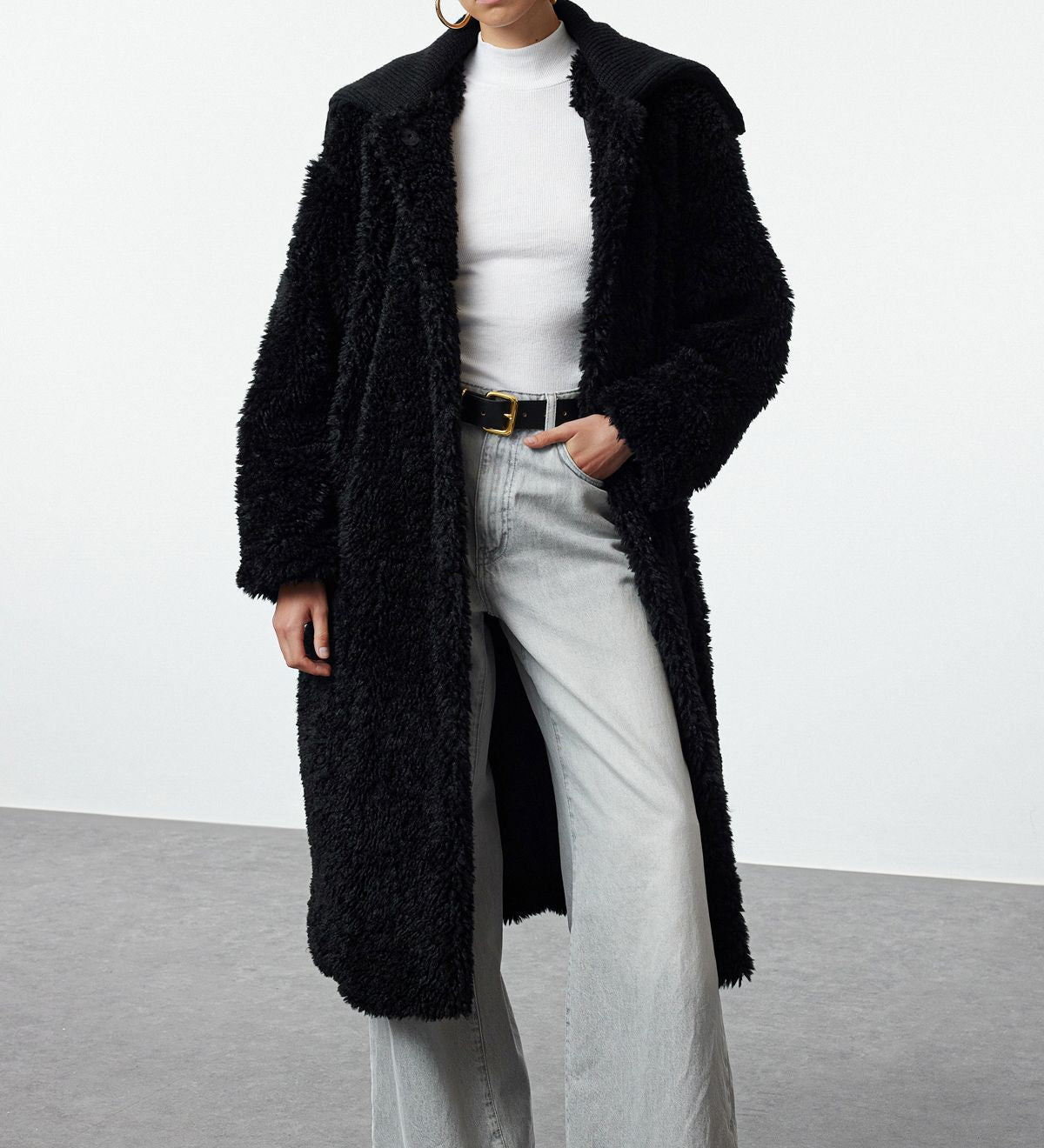 Stay cozy and chic with our Women’s Oversized Black Teddy Coat. Featuring a longline design and plush teddy fleece, this stylish winter coat is perfect for layering over casual or streetwear looks.