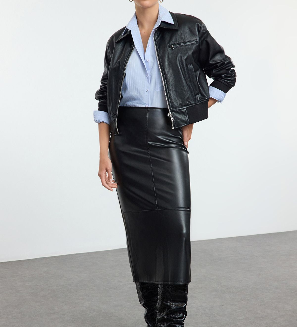 Shop our Faux Leather Midi Skirt for a sleek and versatile style. This high-waisted, midi-length skirt is perfect for day-to-night looks, offering a chic leather-like finish.