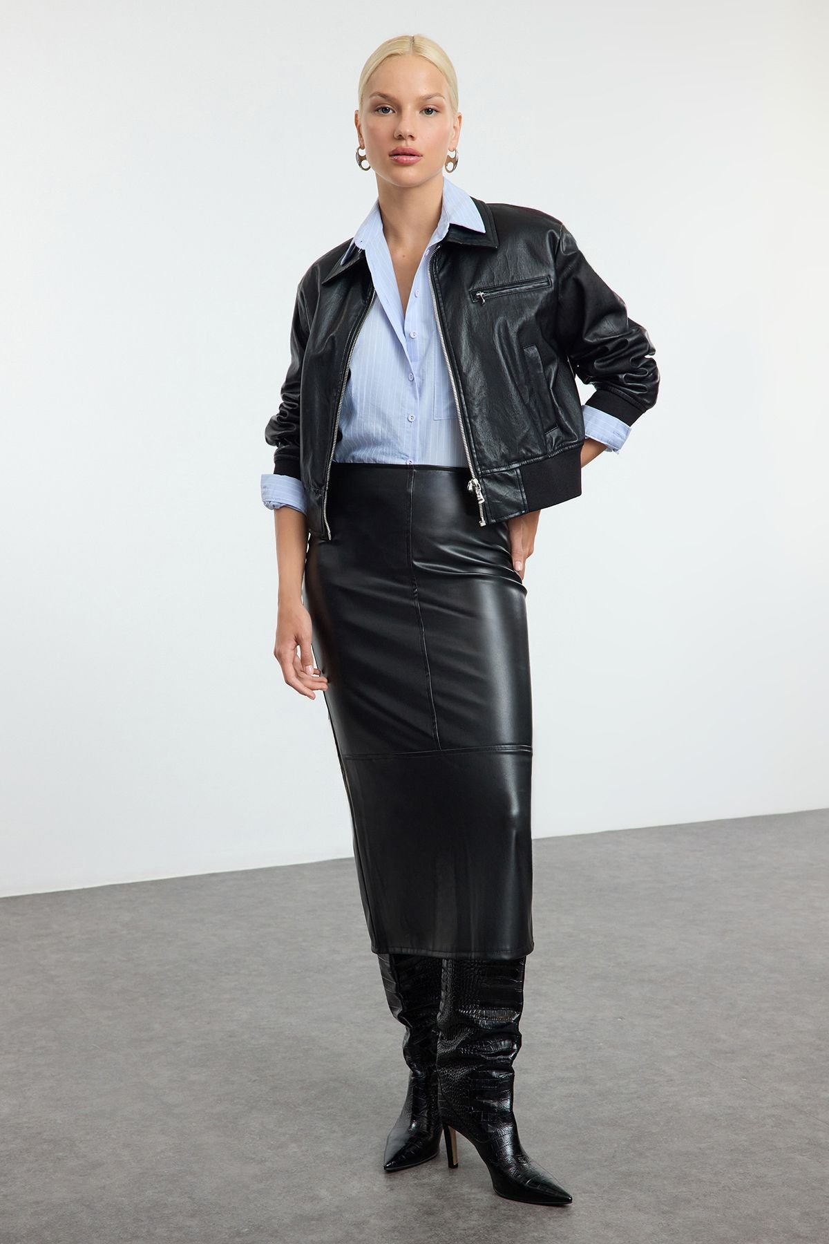 Shop our Faux Leather Midi Skirt for a sleek and versatile style. This high-waisted, midi-length skirt is perfect for day-to-night looks, offering a chic leather-like finish.