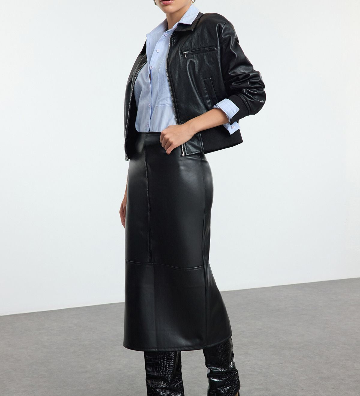 faux leather midi skirt, leather-look skirt, women’s faux leather clothing, high-waisted skirt, black midi skirt, sleek leather skirt, edgy leather style, versatile leather skirt, women’s statement skirts, fashion midi skirts