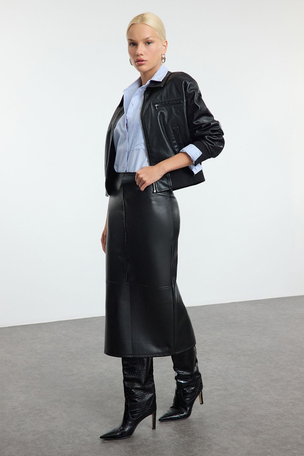 faux leather midi skirt, leather-look skirt, women’s faux leather clothing, high-waisted skirt, black midi skirt, sleek leather skirt, edgy leather style, versatile leather skirt, women’s statement skirts, fashion midi skirts
