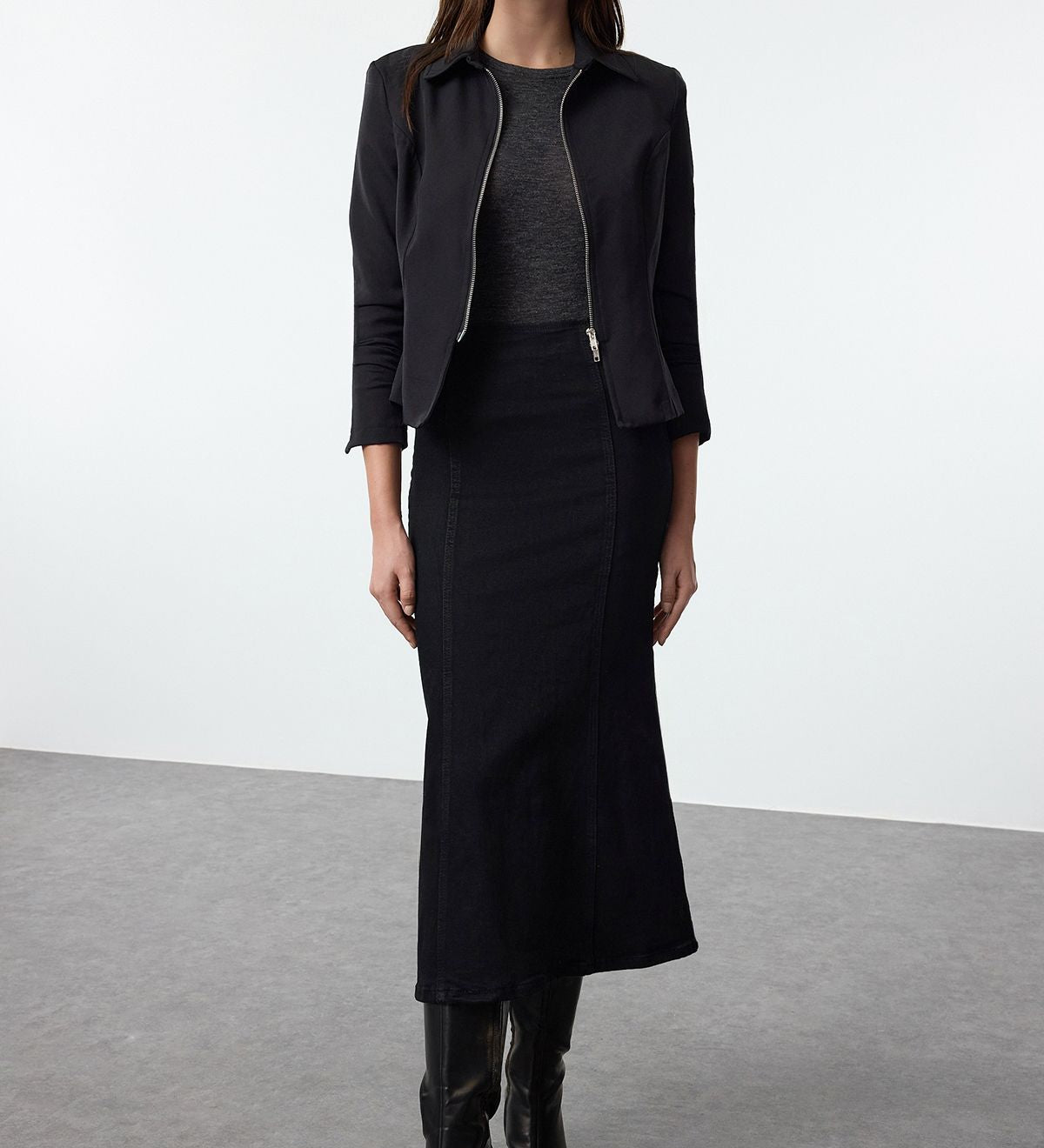 Discover timeless fashion with our high-waisted black denim midi skirt. Perfect for casual or formal wear, this soft denim skirt offers versatile styling options for every season.
