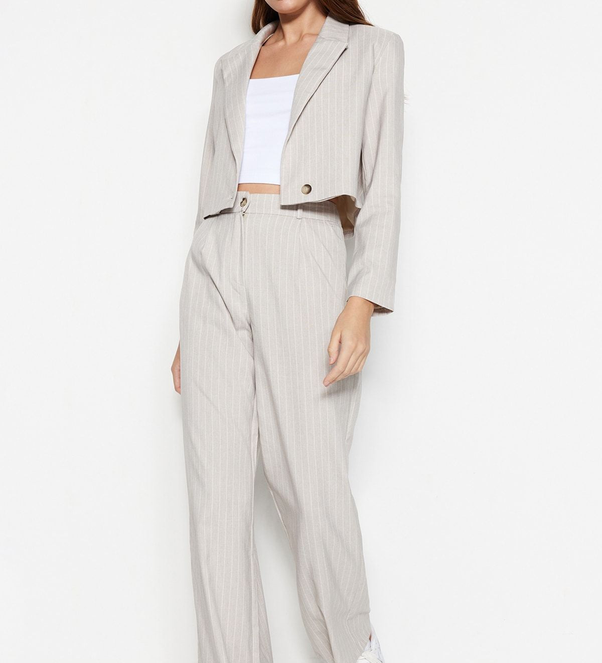 Upgrade your wardrobe with our Beige Pinstripe Cropped Blazer Set. This tailored two-piece suit combines a chic cropped blazer and high-waisted trousers for a versatile, stylish look. Perfect for work or play. Shop now!