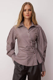  Woman wearing a brown and white striped button-up blouse with tailored waist and puff sleeves – AtikaStyle.”
