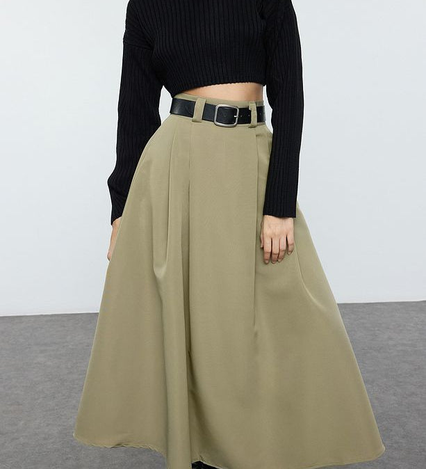 Woman wearing beige high-waist A-line maxi skirt with black boots – AtikaStyle

Close-up of beige maxi skirt with pleated details – AtikaStyle

Side view of beige maxi skirt with pockets – AtikaStyle