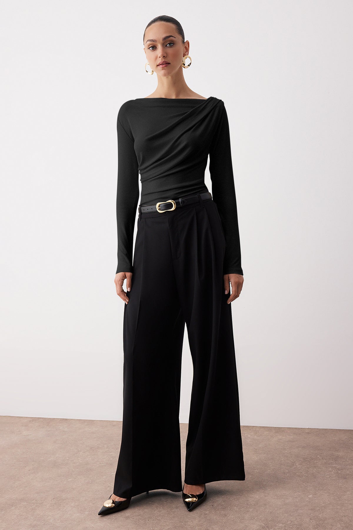  Elegant woman wearing black draped one-shoulder long sleeve top – stylish evening blouse by AtikaStyle
