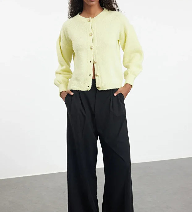 Soft pastel yellow knit fabric
	•	Long sleeves with ribbed cuffs
	•	Button-up front closure
	•	Relaxed, easy fit for layering
	•	Made in Turkey with quality craftsmanship
