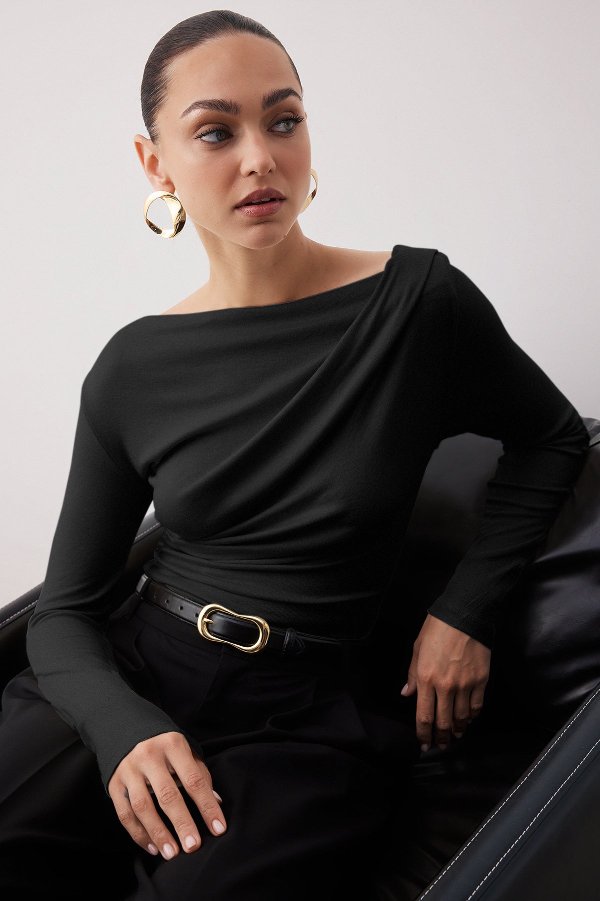  Elegant woman wearing black draped one-shoulder long sleeve top – stylish evening blouse by AtikaStyle
