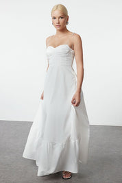 Woman wearing Atikastyle white bustier maxi slip dress with spaghetti straps – elegant long gown for women.”
