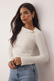 Elevate your style with AtikaStyle’s white textured long sleeve top, featuring a soft woven fabric and gold shoulder accent—perfect for chic everyday or evening looks.