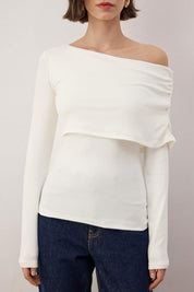  White off-shoulder asymmetric long sleeve ribbed top on model – AtikaStyle

