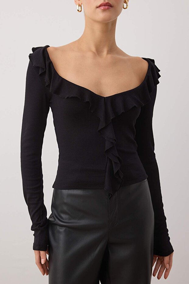 Close-up – black rib knit ruffle front blouse