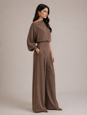 Side view of mocha satin matching set with flowy wide-leg pants and asymmetrical top