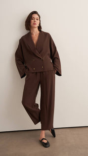 Chocolate brown women’s matching set with relaxed wrap top and flowy wide-leg pants