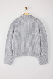 Gray knitted sweater on a wooden hanger against a white background