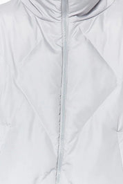 Close-up of a light gray quilted jacket with a zipper