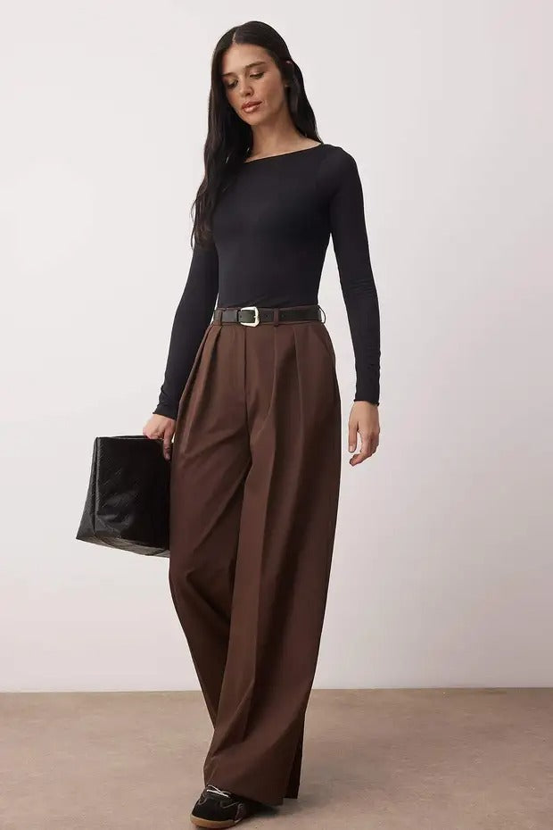 Woman wearing chocolate brown high-waist wide-leg tailored trousers with flowy drape – AtikaStyle.”
