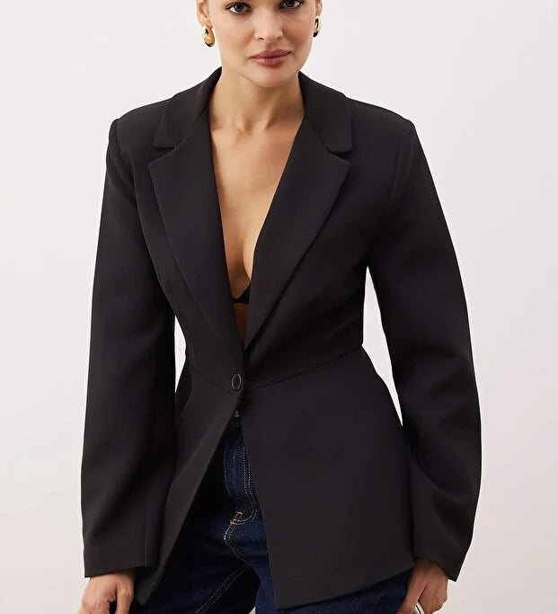 A woman wearing a black fitted single-button blazer jacket with a tailored silhouette — AtikaStyle.
