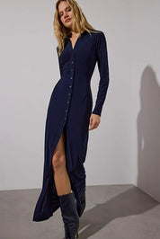 Navy long-sleeve button-down maxi dress by AtikaStyle. Elegant silhouette with a front slit for a modern, feminine touch. Perfect for workwear or evening style. Made in Turkey.
