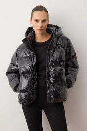 Person wearing a black puffer jacket against a white background