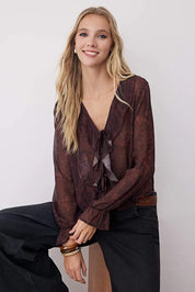 Woman wearing a brown blouse with a white background