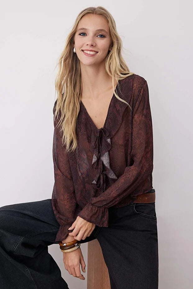 Woman wearing a brown blouse with a white background