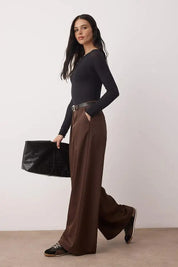 Woman wearing chocolate brown high-waist wide-leg tailored trousers with flowy drape – AtikaStyle.”
