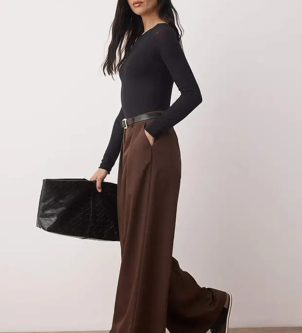 Woman wearing chocolate brown high-waist wide-leg tailored trousers with flowy drape – AtikaStyle.”
