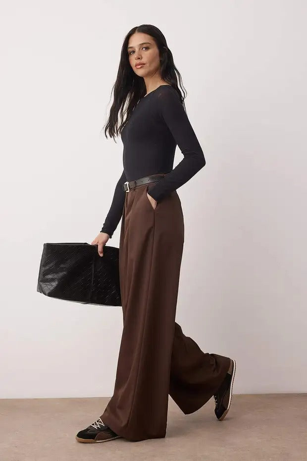 Woman wearing chocolate brown high-waist wide-leg tailored trousers with flowy drape – AtikaStyle.”
