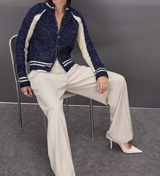 Woman wearing a navy and cream contrast knit zip-up sweater with ribbed sleeves and stripe hem – AtikaStyle.
