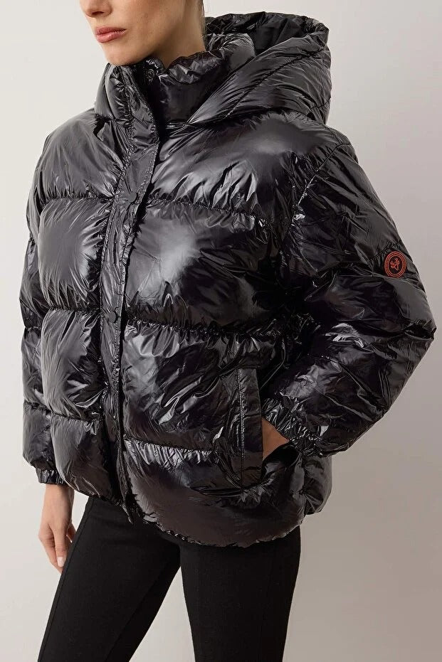 Black puffer jacket worn by a person on a plain background