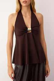 Brown halter top with a gold accent worn by a model on a white background