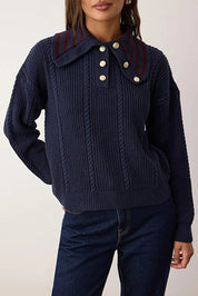 Navy blue knitted sweater with a collar and buttons on a plain background