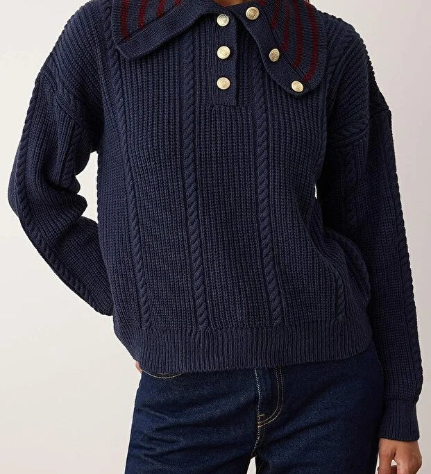 Navy blue knitted sweater with a collar and buttons on a plain background