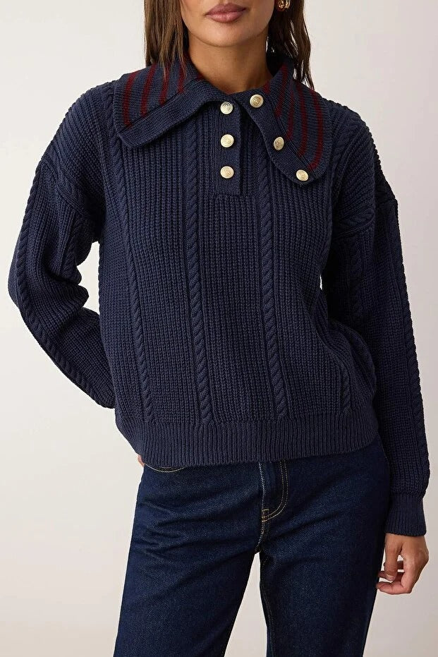 Navy blue knitted sweater with a collar and buttons on a plain background