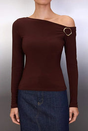 Brown off-shoulder top with a gold buckle detail on a plain background