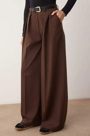 Brown wide-leg pants worn by a person on a plain background