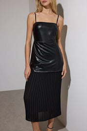 Where bold meets elegant — this black faux leather pleated midi dress from AtikaStyle is your go-to for chic nights out.”
