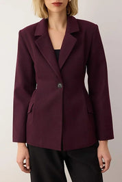 Maroon blazer worn by a person on a plain background