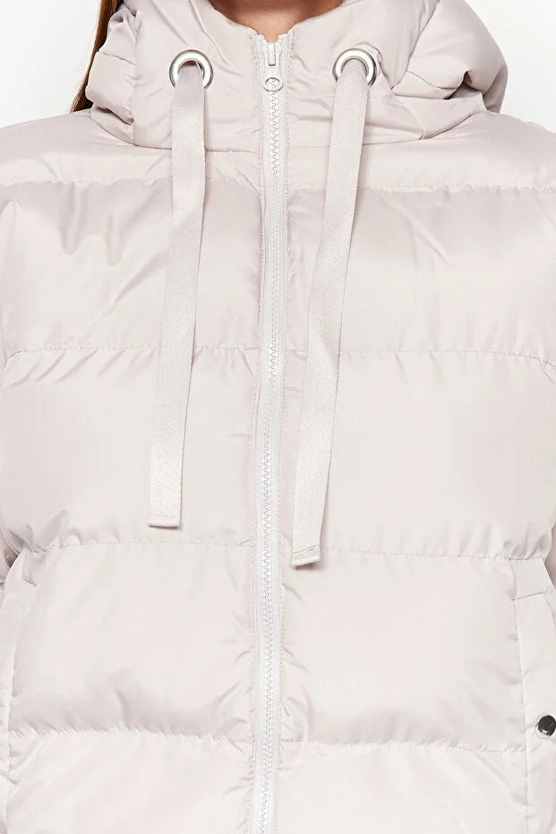 Close-up of a light pink hooded jacket with a zipper on a white background