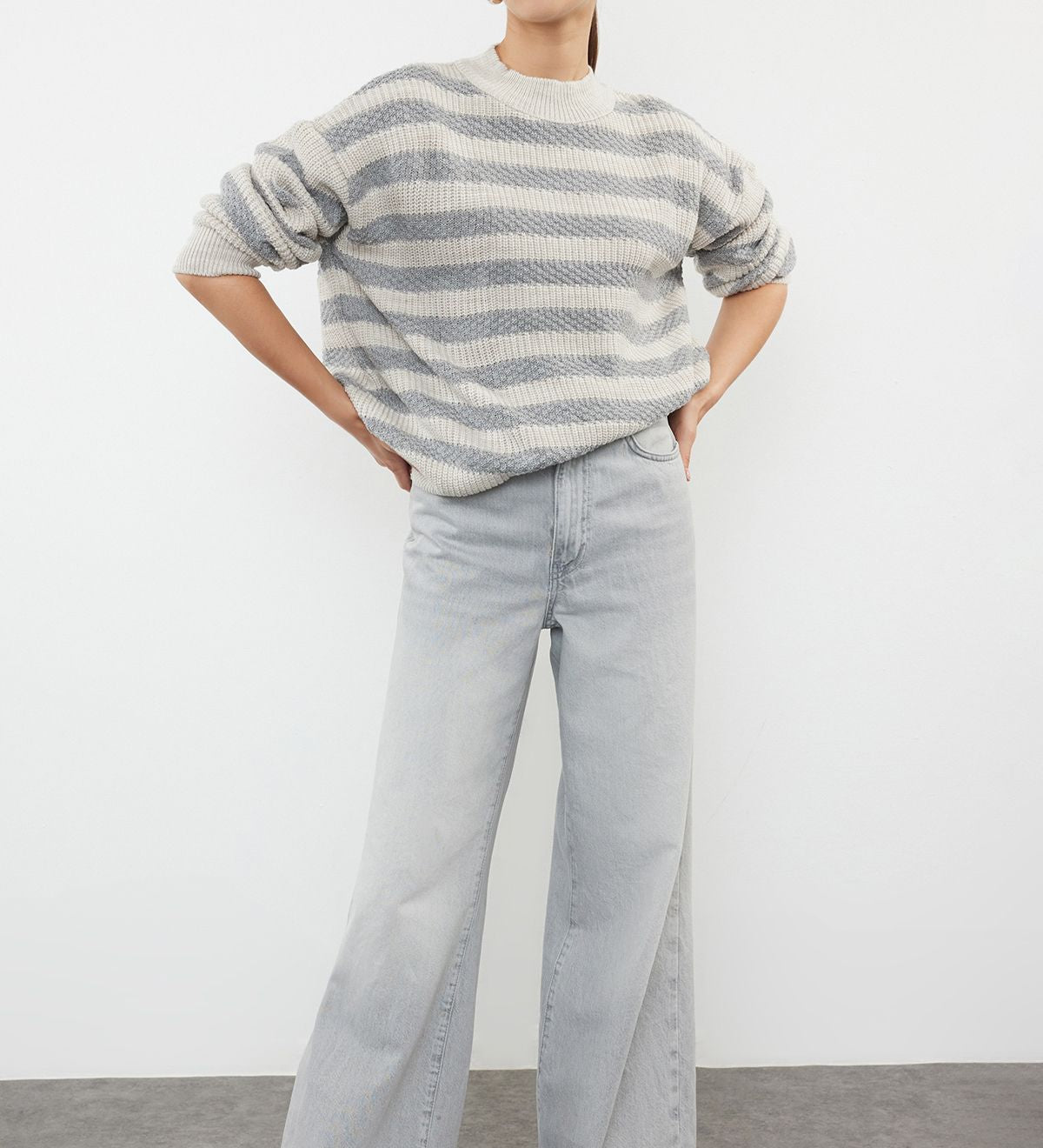 Stay warm and stylish with our Striped Chunky Knit Sweater. Featuring a cozy grey and cream pattern and a relaxed fit, this soft pullover is perfect for any season. Shop now!