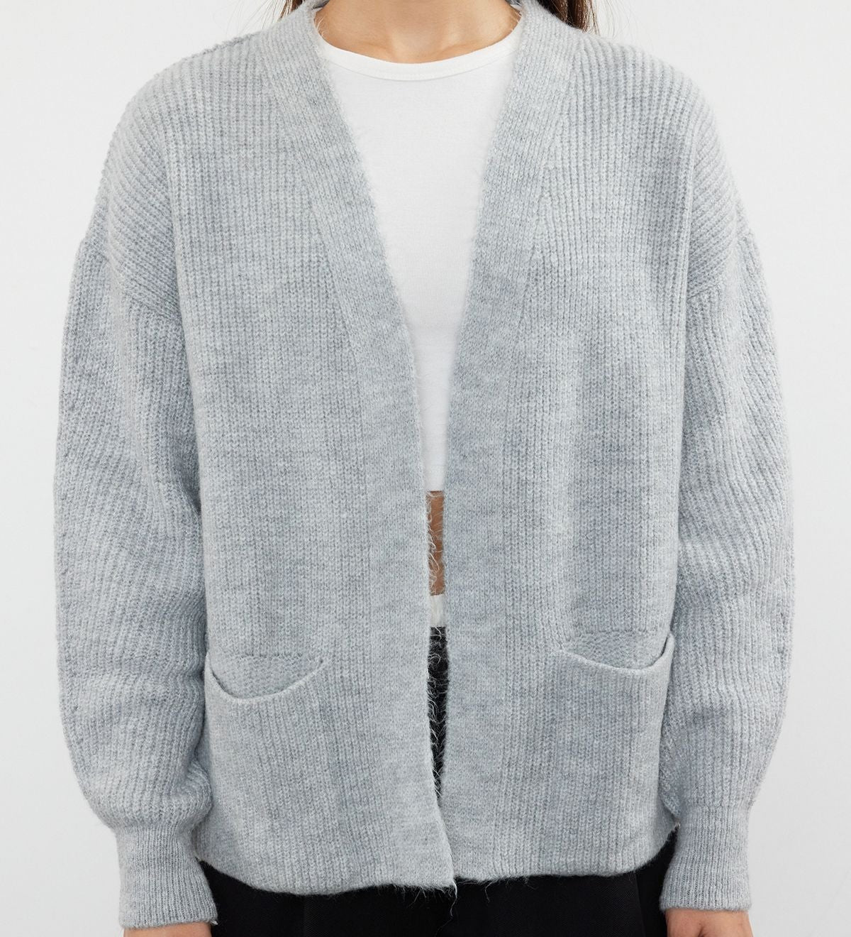  Stay cozy and stylish with our Light Gray Open-Front Cardigan. Featuring a relaxed fit, ribbed texture, and front pockets, this soft wool blend cardigan is perfect for layering over your favorite outfits. Shop now for versatile and chic knitwear!