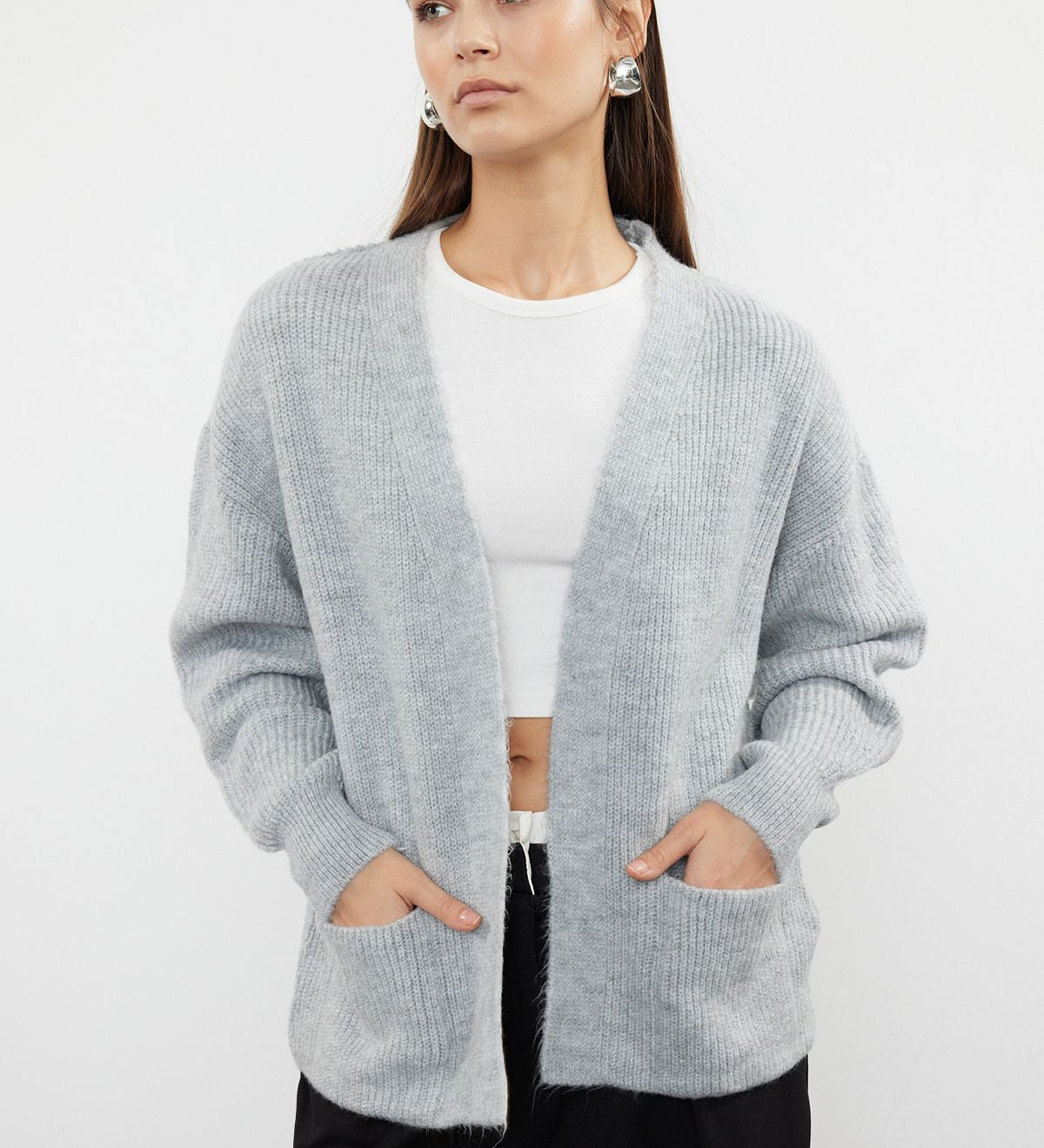  Stay cozy and stylish with our Light Gray Open-Front Cardigan. Featuring a relaxed fit, ribbed texture, and front pockets, this soft wool blend cardigan is perfect for layering over your favorite outfits. Shop now for versatile and chic knitwear!