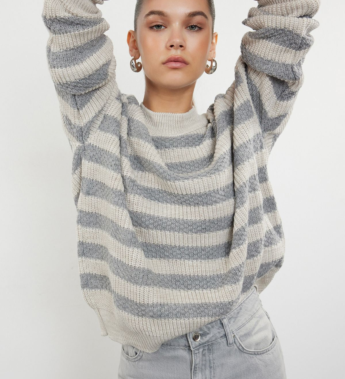  Wrap yourself in comfort with our Cream and Gray Striped Sweater. Featuring a timeless stripe pattern and a soft wool blend, this cozy knit sweater is perfect for layering and adding sophistication to your casual wardrobe. Shop now for elegant and stylish knitwear free shipping!