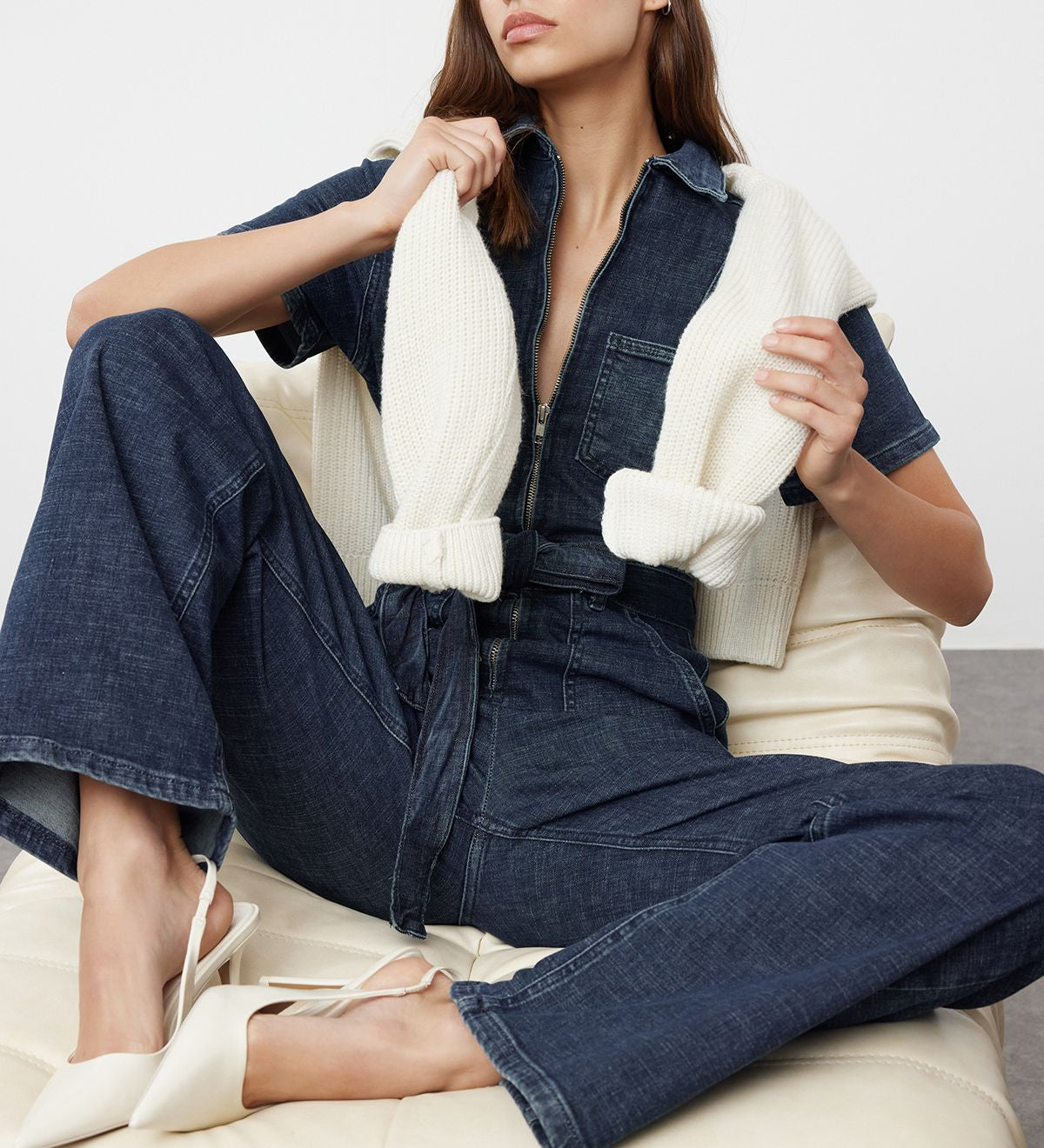 Discover a stylish denim belted jumpsuit for women, featuring a front zipper and adjustable belt. Perfect for casual or smart-casual outfits.